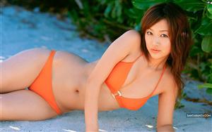 Japanese actress Risa Kudo gives a super-hot pose in an orange bikini